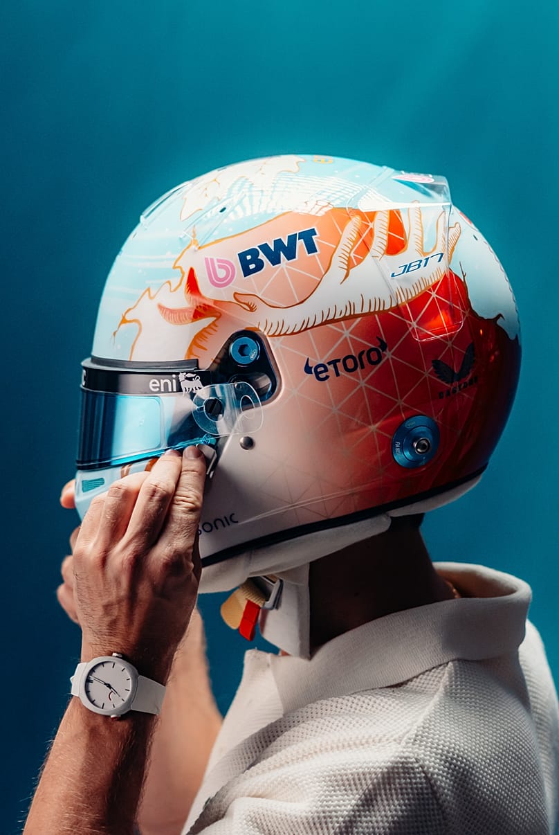 F1 driver Pierre Gasly tries on custom designed helmet by Qatari artist Ghada Al Suwaidi.
