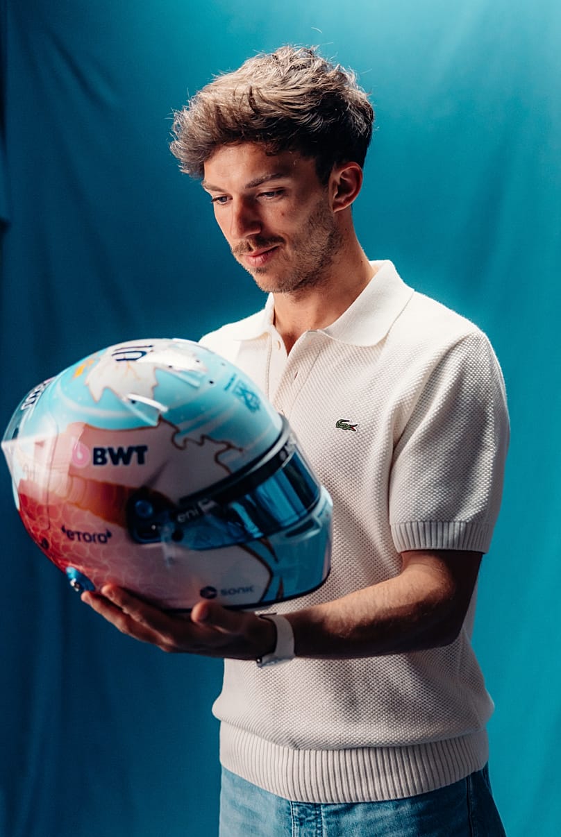F1 driver Pierre Gasly checks out his custom-designed helmet by Qatari artist Ghada Al Suwaidi.