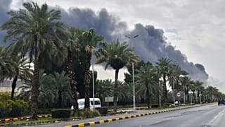 FILE: Smoke rises from Kuwait International Airport after a drone strike on fuel storage in Kuwait City, Kuwait, 25 March 2026