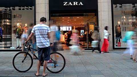 People walk past a Zara store in Barcelona, Spain, Aug. 2021