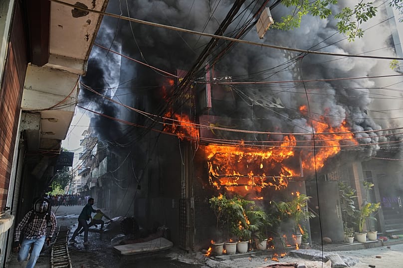 Local people attempt to douse a fire at a hotel in New Delhi, 3 June, 2026