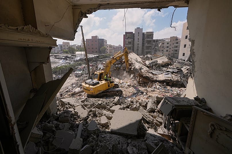 Rescue workers search for victims under the rubble of a building that was hit Monday in an Israeli airstrike in the southern port city of Tyre, Lebanon, June 2, 2026. 