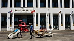 Fishermen on makeshift rafts sail past the Paseo del Prado hotel, part of the Canadian Blue Diamond chain, in Havana.