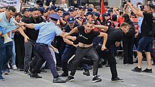 Protesters scuffle with police officers blocking a street during a demonstration in Tirana, 3 June, 2026