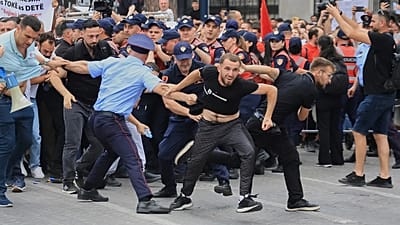 Protesters scuffle with police officers blocking a street during a demonstration in Tirana, 3 June, 2026