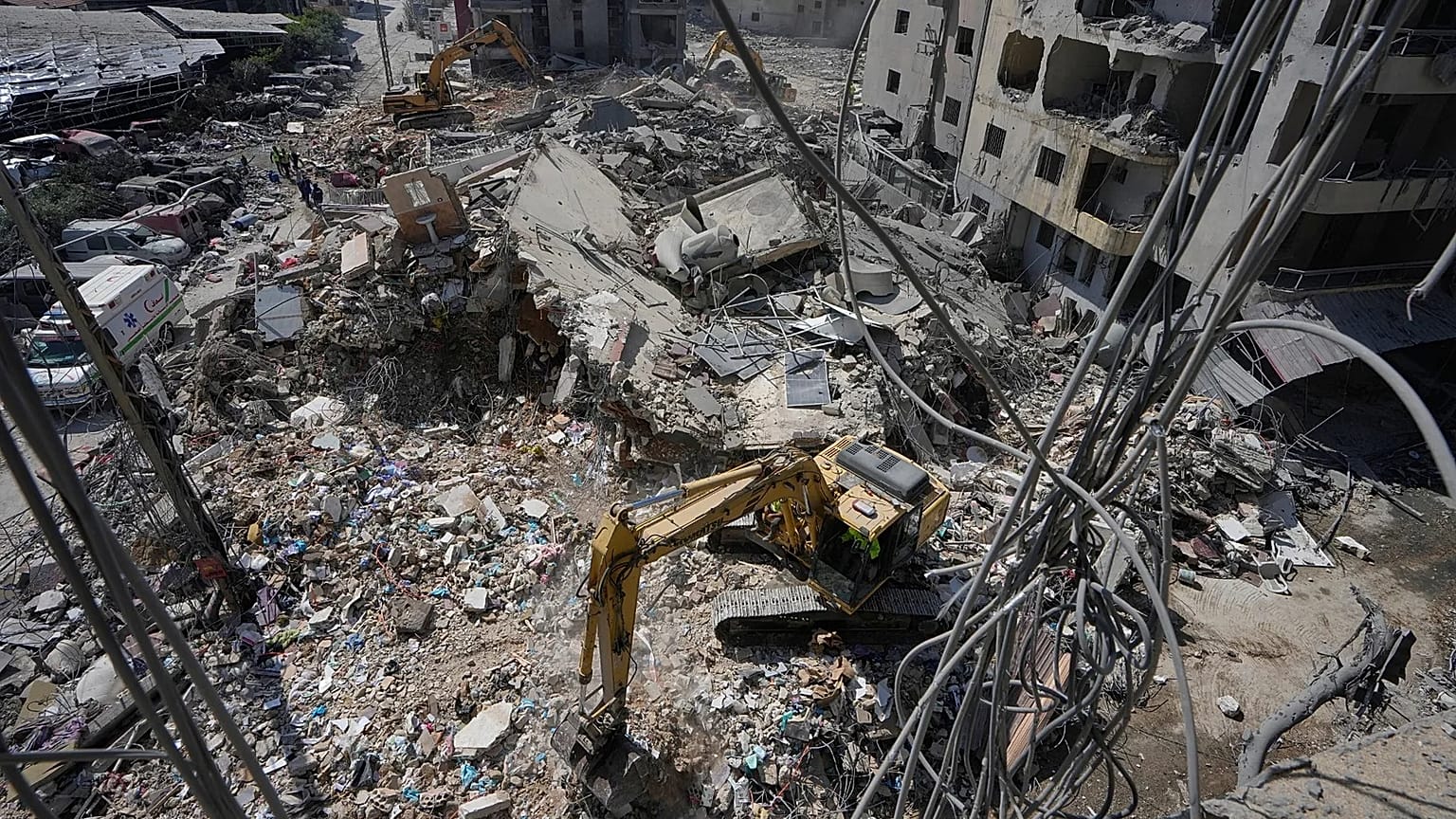 Rescue worker searches for victims under the rubble of a building that was hit Monday in an Israeli strike in the southern city of Tyre, 2 June, 2026