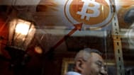 FILE. A man uses a Bitcoin ATM in Hong Kong, Jan. 2018
