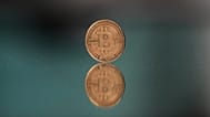 FILE - A bitcoin token is placed on a mirror for a photograph in Prague, Czech Republic. 11 May 2025. 