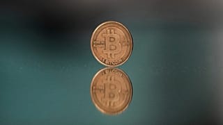 FILE - A bitcoin token is placed on a mirror for a photograph in Prague, Czech Republic. 11 May 2025. 