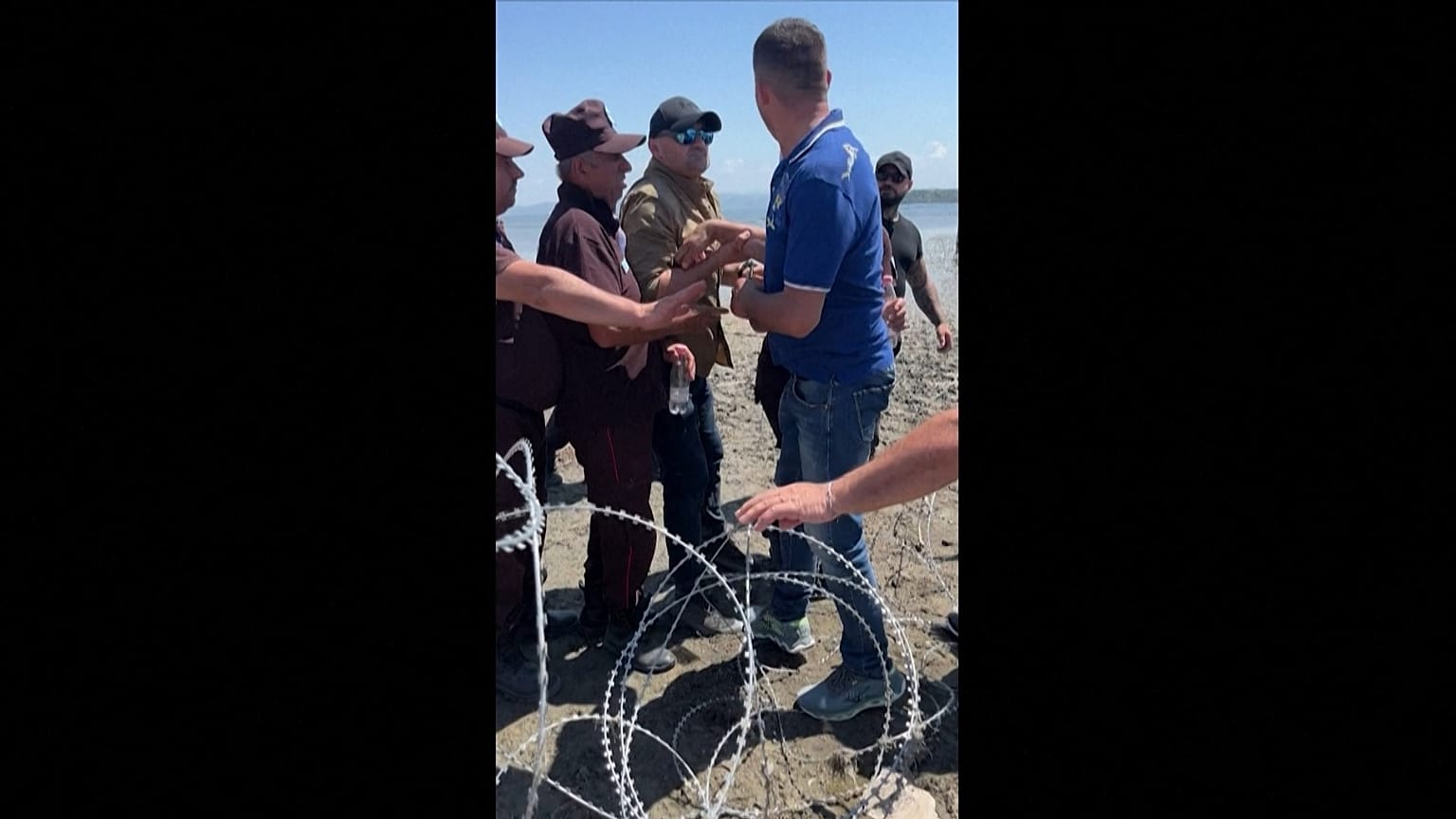 Private security guards restrain and drag a protester during a clash with demonstrators opposing a coastal resort project in Zvërnec, western Albania.