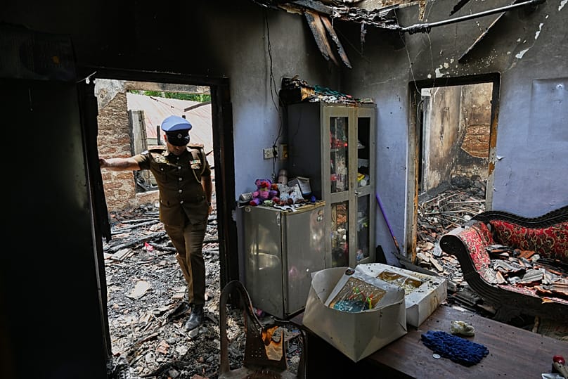 Sri Lankan police inspect a charred elderly care home following an overnight fire in Anguruwatota, 4 June, 2026