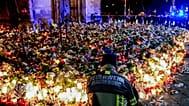 Flowers are laid in front of the Johannis church near the Christmas Market in Magdeburg, 23 December, 2024