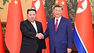 Chinese President Xi Jinping, right, poses for photos with North Korean leader Kim Jong Un at the Great Hall of the People in Beijing, China, Thursday, Sept. 4, 2025. (Huang J