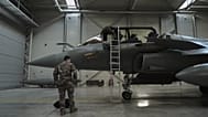 A flight-crew member climbs into the cockpit of a French air force Rafale fighter jet stationed on a NATO air-policing mission at the Siauliai Air Base in Lithuania.
