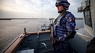 A Romanian naval serviceman guards onboard the M-270 Mine-hunter during a Romanian Navy led exercise outside Constanta, Romania, Tuesday, April 16, 2024.