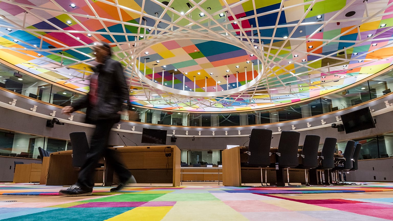 A man walks inside the main meeting room at the Europa building in Brussels on Friday, Dec. 9, 2016. 