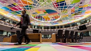 A man walks inside the main meeting room at the Europa building in Brussels on Friday, Dec. 9, 2016. 