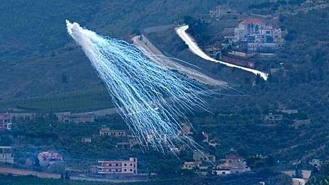 A shell that appears to be white phosphorus, fired by Israeli artillery, explodes over Kfar Kila, a Lebanese village on the Israeli border, on 22 November 2023
