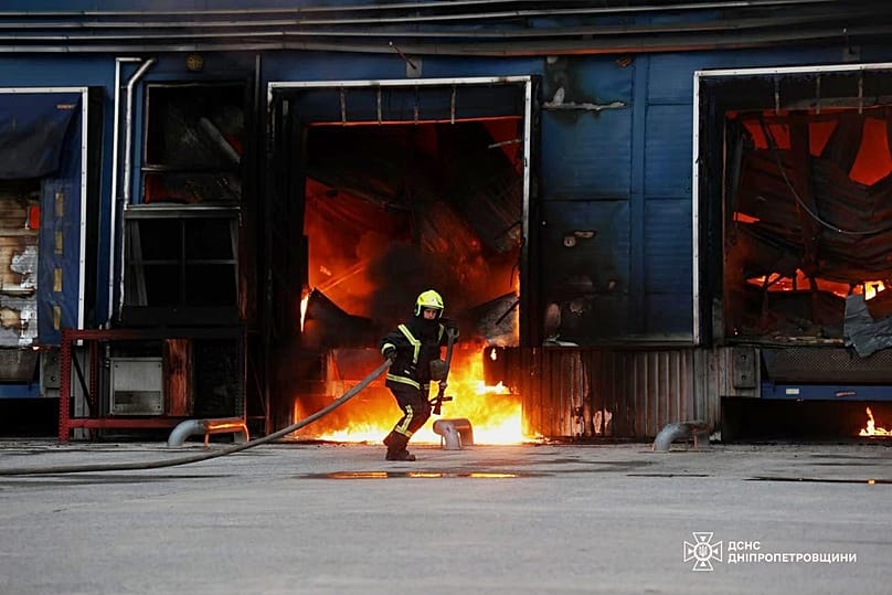 A rescue worker puts out a fire of a storage depot damaged after a Russian strike on the Dnipropetrovsk region, 4 June, 2026 
