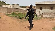A Malian police office patrols outside Campement Kangaba, a tourist resort near Bamako, 19 June, 2017