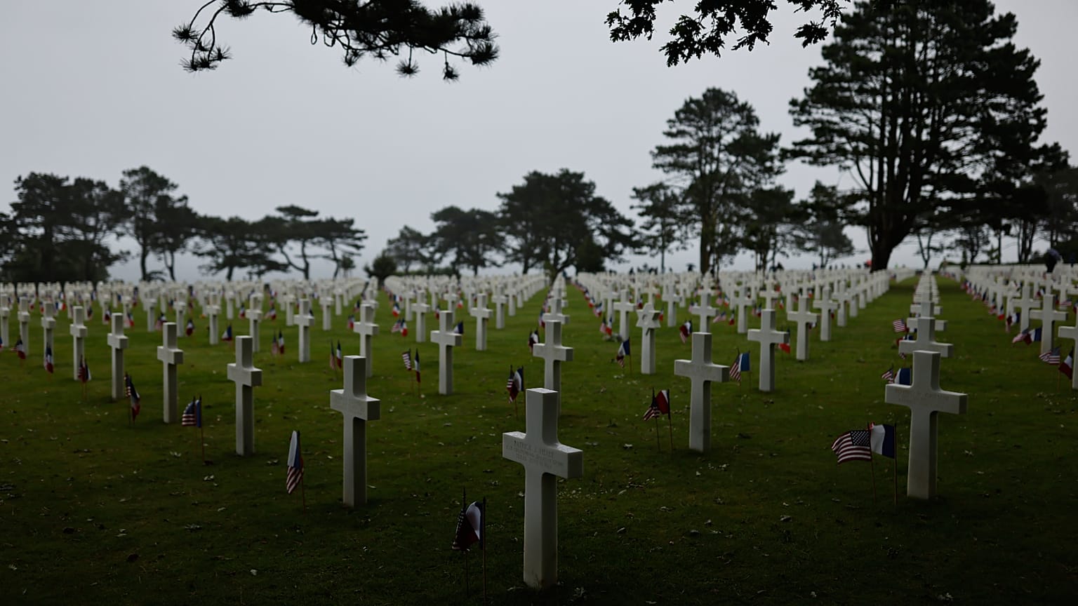  American and French flags lie next to headstones at the US cemetery to commemorate the 82nd anniversary of the D-Day landings, in Colleville-sur-Mer, Normandy, France, Saturd