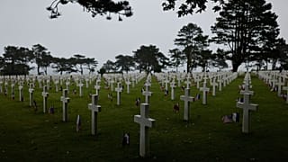  American and French flags lie next to headstones at the US cemetery to commemorate the 82nd anniversary of the D-Day landings, in Colleville-sur-Mer, Normandy, France, Saturd