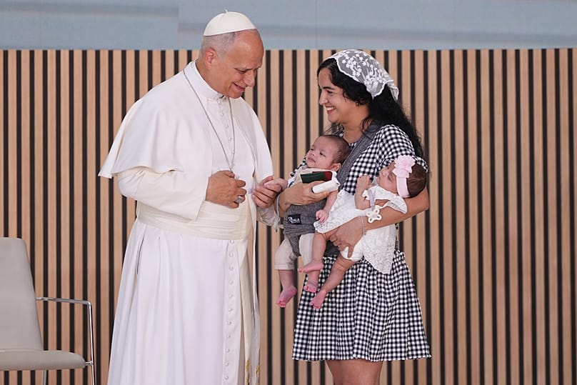 Pope Leo XIV talks to Niurka, a mother of two, during his visit to the CEDIA 24 Horas Social Project center in Madrid, Saturday, June 6, 2026