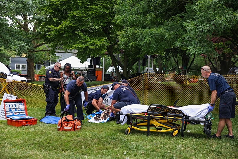 First responders help a woman who was injured the mass shooting that left 12 people injured at the Old West End Festival in Toledo on Saturday, June 6, 2026