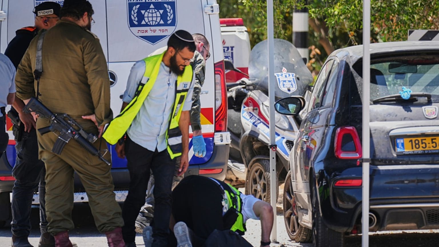 Israeli security forces and ZAKA rescue service volunteers respond at the scene of a shooting attack near Tzur Yitzhak in central Israel, Sunday, June 7, 2026