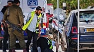 Israeli security forces and ZAKA rescue service volunteers respond at the scene of a shooting attack near Tzur Yitzhak in central Israel, Sunday, June 7, 2026