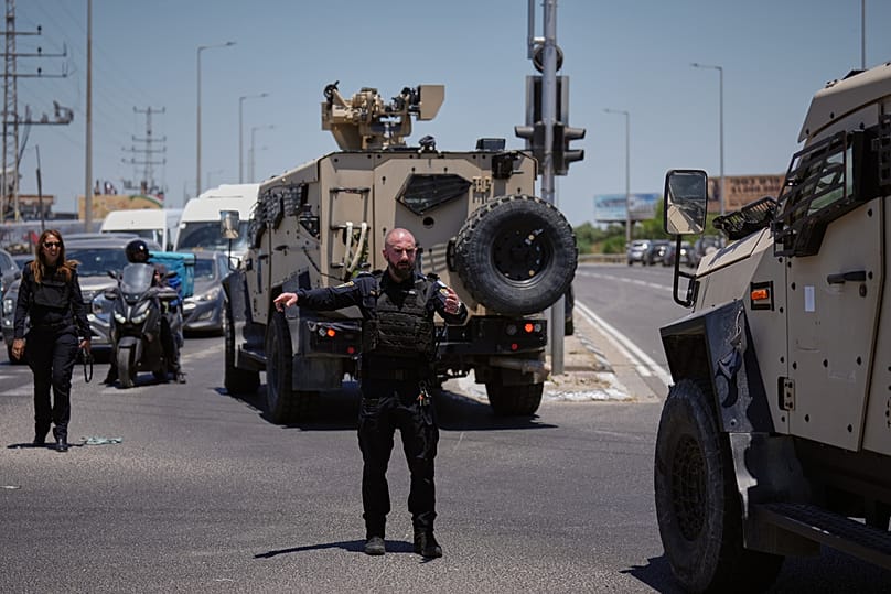 Israeli police officers are deployed at the scene of a shooting attack near Tzur Yitzhak in central Israel, Sunday, June 7, 2026