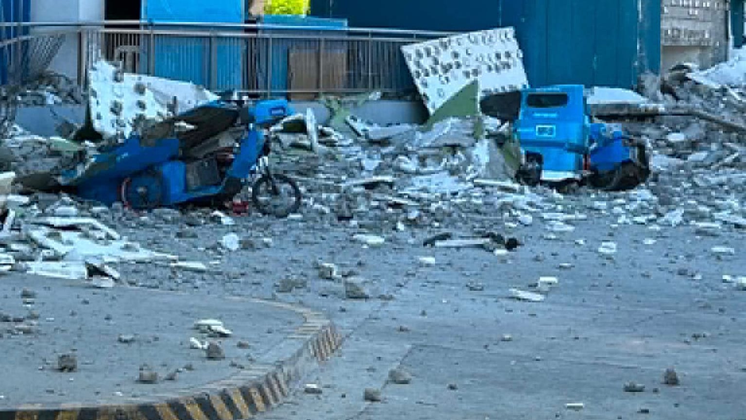 This shows vehicles damaged by debris after powerful earthquake in the Mindanao region, Philippines Monday, June 8, 2026.