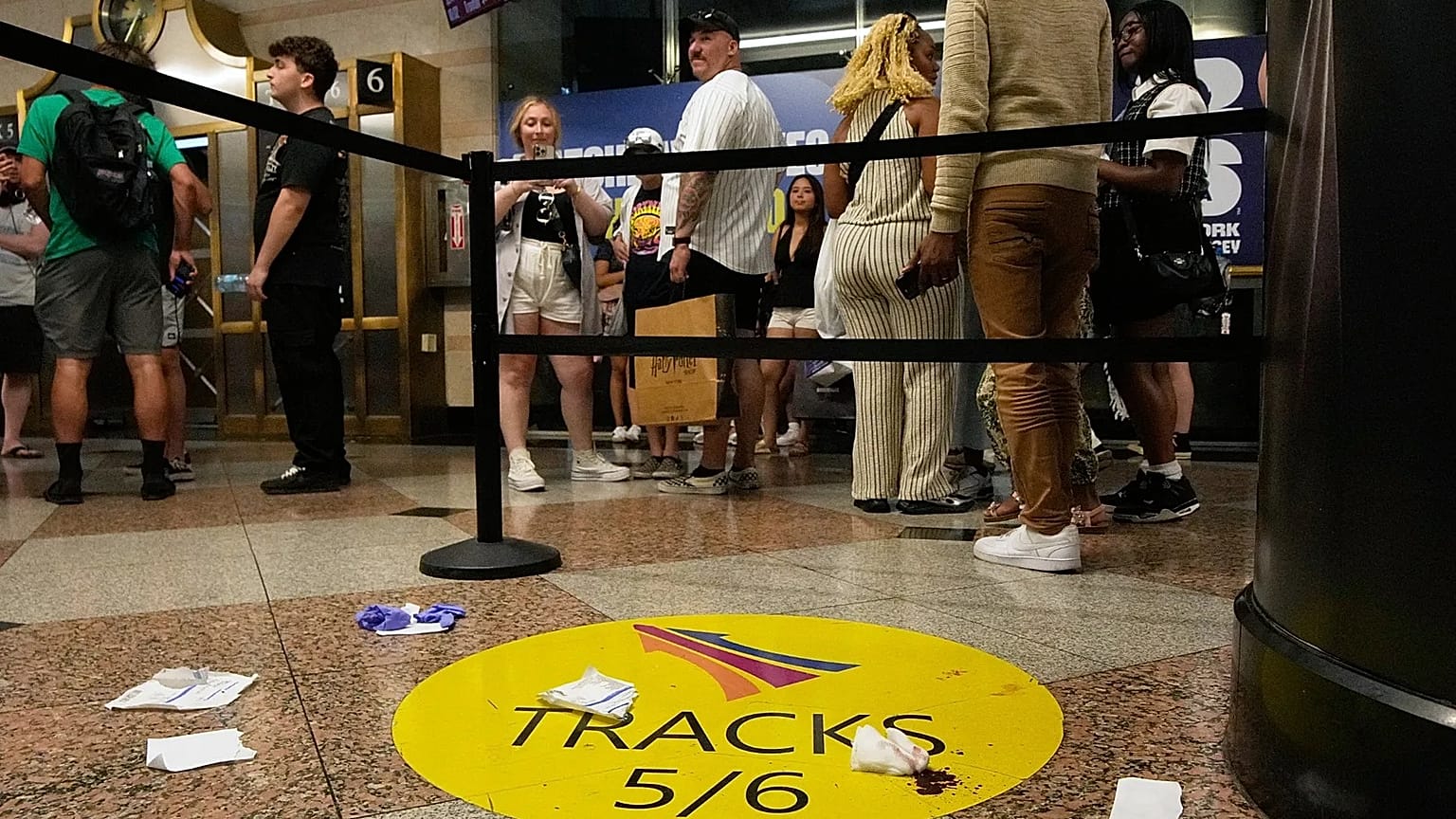 People stand near an area roped off after a stabbing at Penn Station in New York, 7 June, 2026