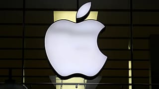 The logo of Apple is illuminated at a store in the city center in Munich, Germany, Wednesday, Dec. 16, 2020