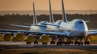 FILE - In this Monday, 20 April 2020 file photo Boeing 747 aircrafts of German Lufthansa are parked at the airport in Frankfurt, Germany.
