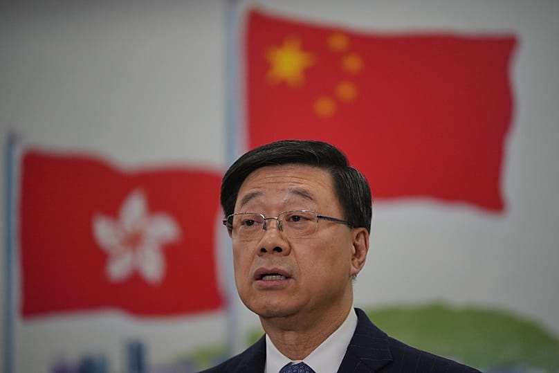 Hong Kong's Chief Executive John Lee speaks to the media during a press conference in Beijing, 16 December, 2025