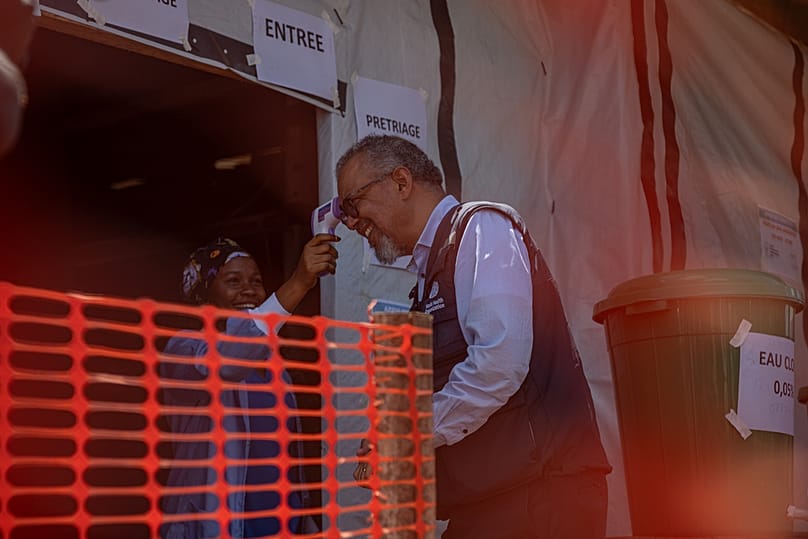 A health worker takes the temperature of the Director General of the World Health Organisation, Tedros Adhanom Ghebreyesus,  in Bunia, Congo, Sunday, May 31, 2026. 
