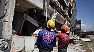 Rescuers inspect a damaged building following an earthquake in General Santos, 9 June, 2026
