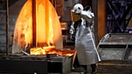 FILE. A worker walks next to a furnace at the ThyssenKrupp steel factory in Duisburg, Germany, Jan. 2020