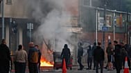 A building is set light to by protesters in central Belfast following a stabbing incident in Belfast