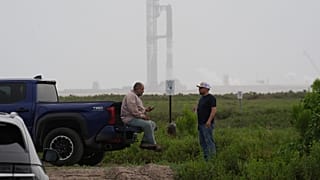 Workers wait for a road to reopen as SpaceX's Starship mega rocket goes through testing at Starbase, Texas, 20 May 2026