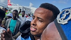 Referee Omar Artan, who was denied entry to the United States, is welcomed by supporters upon his arrival 