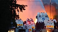 Police attempt to disperse protesters with water canon in Newtownabbey, near Belfast, Northern Ireland, Wednesday, June 10, 2026, demonstrations follow a stabbing in Belfast.