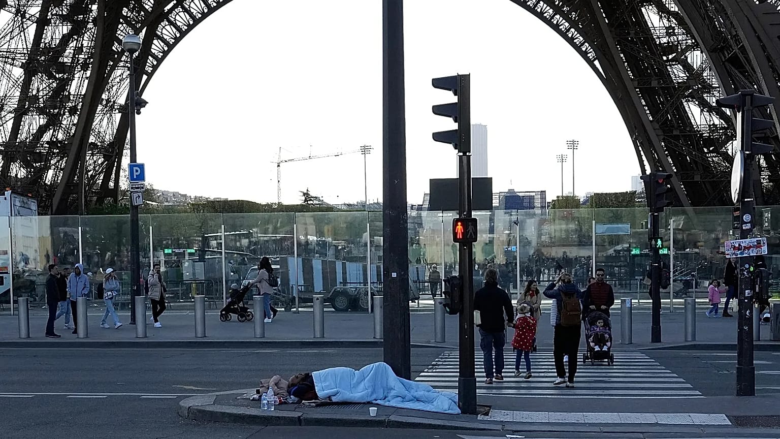 File - A homeless sleeps just next to the Eiffel Tower Wednesday, 10 Apri 2024 in Paris. 