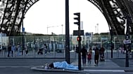 File - A homeless sleeps just next to the Eiffel Tower Wednesday, 10 Apri 2024 in Paris. 