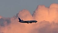 An Air Europa Boeing 737 approaches for landing in Lisbon at sunrise, Monday, May 4, 2026.