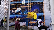 People walk past a street art painting featuring Brazilian soccer legend Pele ahead of the inauguration of the FIFA World Cup in Guadalajara, Mexico, Wednesday, June 10, 2026