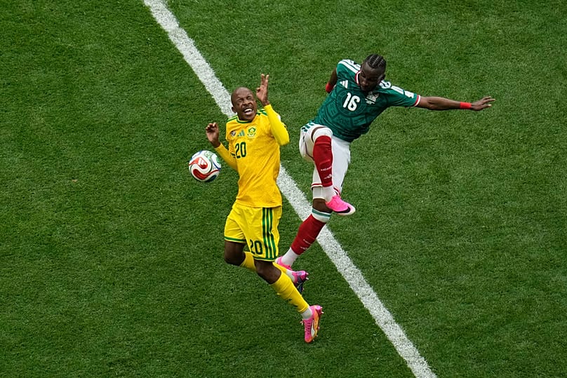 Mexico's Julian Quinones and South Africa's Khuliso Mudau challenge for the ball during the World Cup match between Mexico and South Africa in Mexico City, June 11, 2026