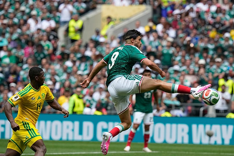 Mexico's Raul Jimenez chased by South Africa's Mbekezeli Mbokazi during the World Cup Group A soccer match between Mexico and South Africa in Mexico City, June 11, 2026