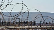 FILE - Migrants rescued south of Crete walk after their arrival at the the port of Lavrio, Greece, on July 10, 2025